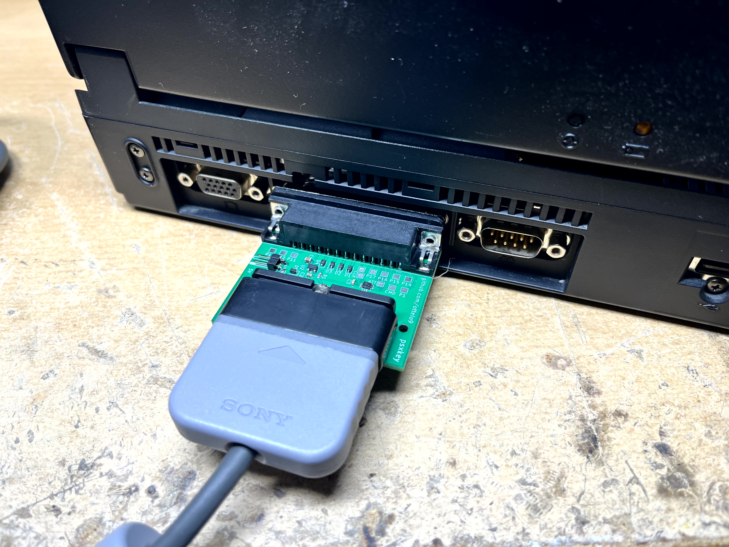 PSXKEY adapter in the parallel port of a laptop